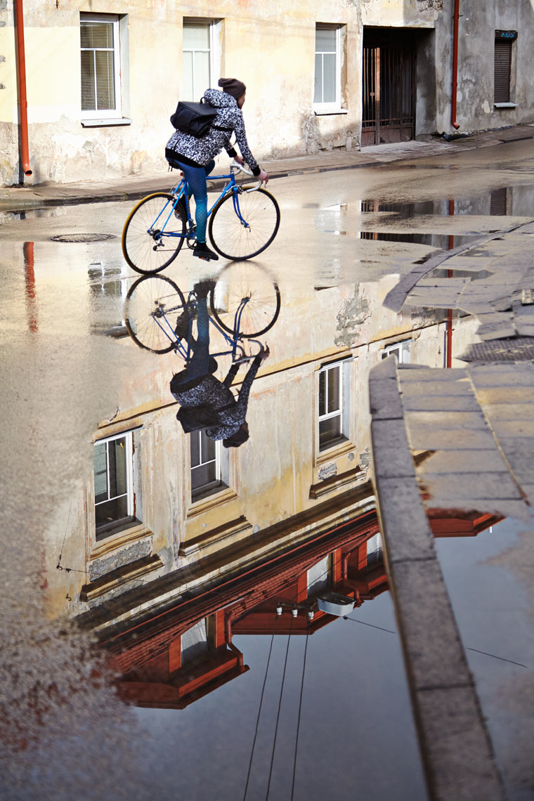 Cyclist and reflection in Uzupis