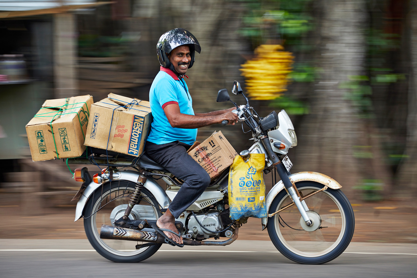Happy-moped-rider-Colombo-main-road-Sri-Lanka-web